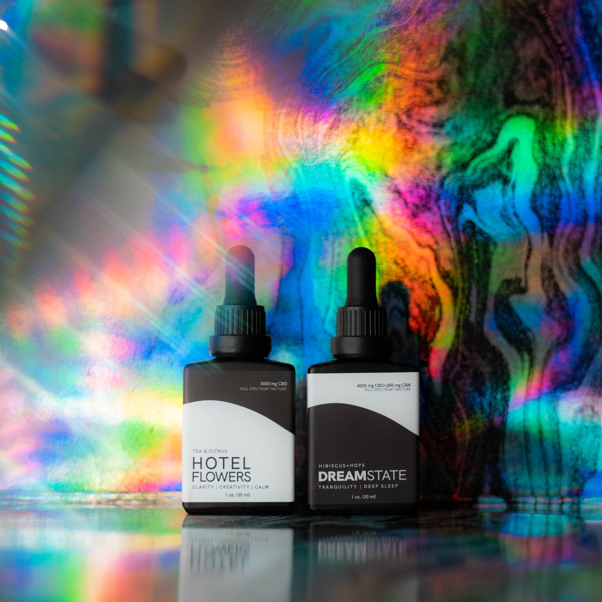 hotel flowers and dream state tinctures in front of colorful background with cool light effects